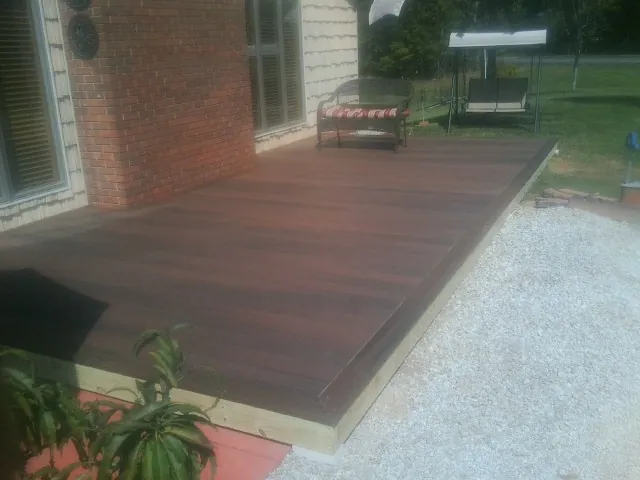 Freshly stained wood deck built against a brick home in Houston